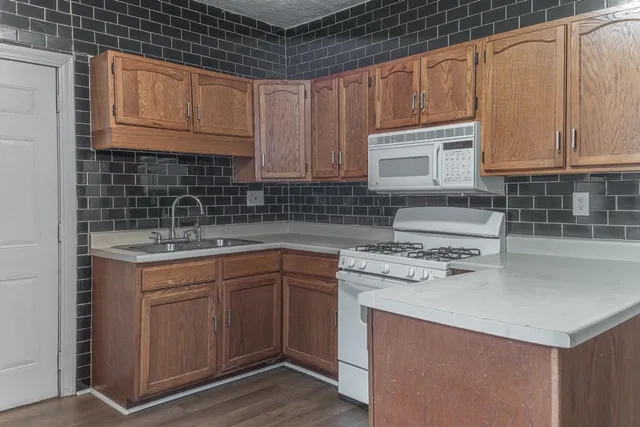 a kitchen with a sink stove and cabinets