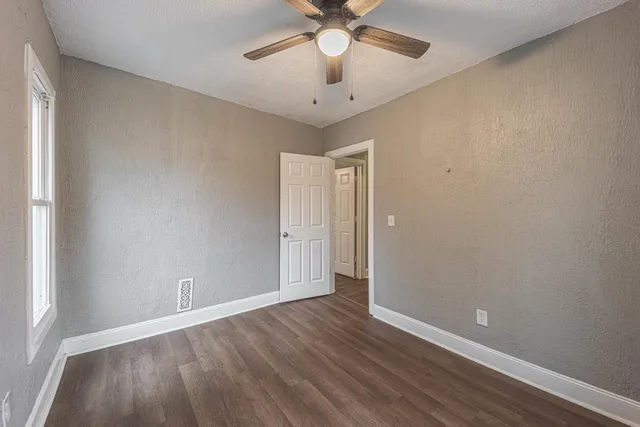 wooden floor in an empty room with a window