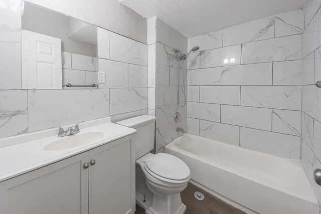 a bathroom with a sink toilet and shower