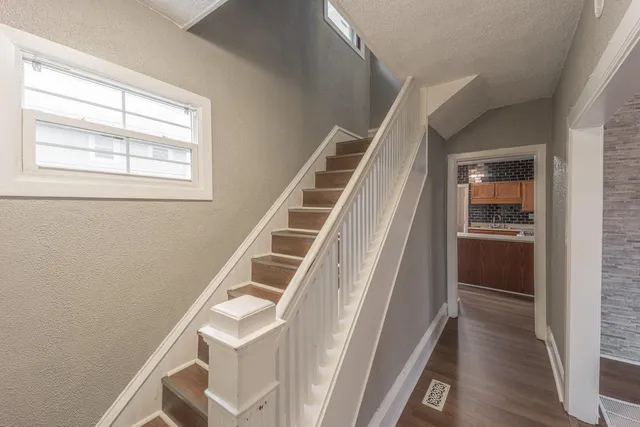 a house with wooden floor and white walls