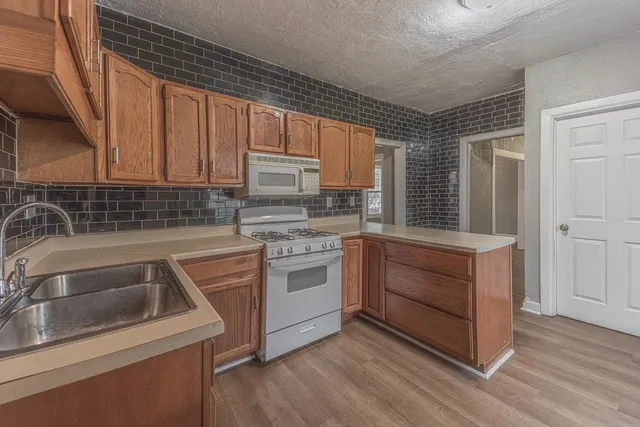 a kitchen with a sink stove and cabinets