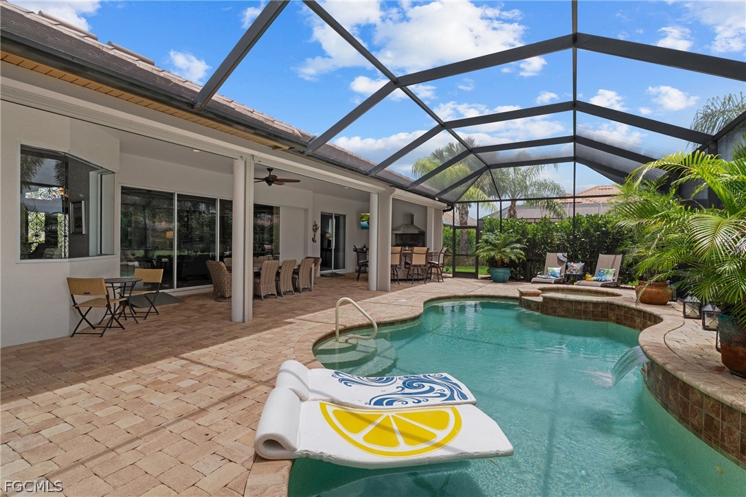 9383 Slate Court Naples, FL 34120 - Photo 2 of 28 a view of a swimming pool with a patio