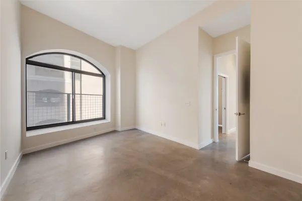 an empty room with windows and closet