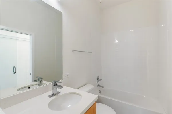 a bathroom with a sink toilet and bathtub
