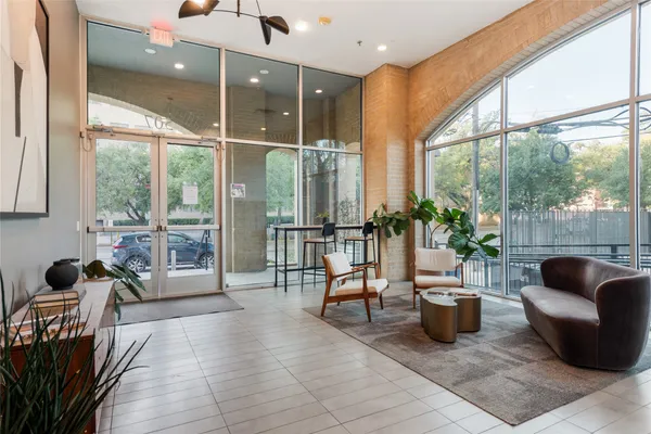 a lobby with furniture and potted plant