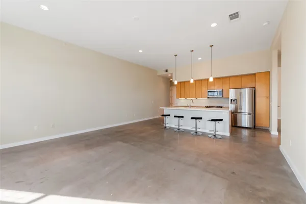an empty room with furniture and a chandelier