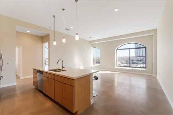 a view of a kitchen with a sink and a window
