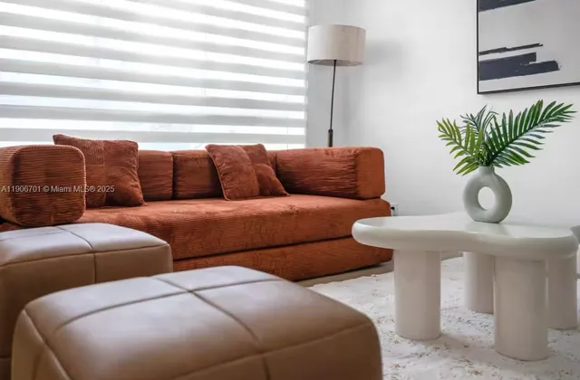 a kitchen with stainless steel appliances a stove a sink a microwave a refrigerator a dining table and chairs