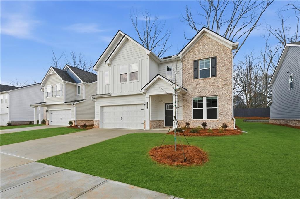 113 St Anne's Place Covington, GA 30016 - Photo 2 of 31 a front view of a house with a yard and trees