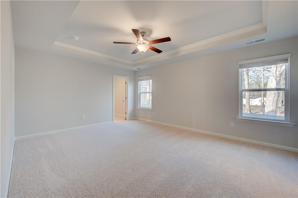 113 St Anne's Place Covington, GA 30016 - Photo 22 of 31 an empty room with windows and fan