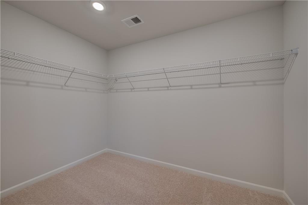 113 St Anne's Place Covington, GA 30016 - Photo 23 of 31 a view of a room with racks on the wall