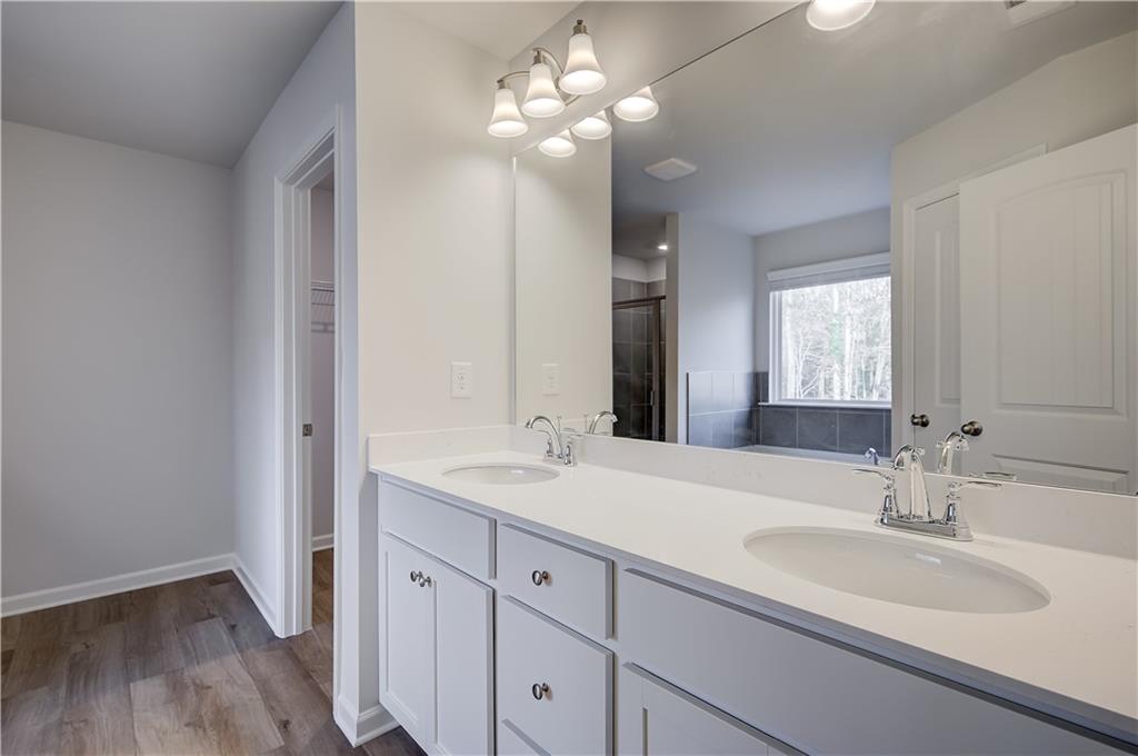 113 St Anne's Place Covington, GA 30016 - Photo 26 of 31 a bathroom with a sink vanity and a mirror