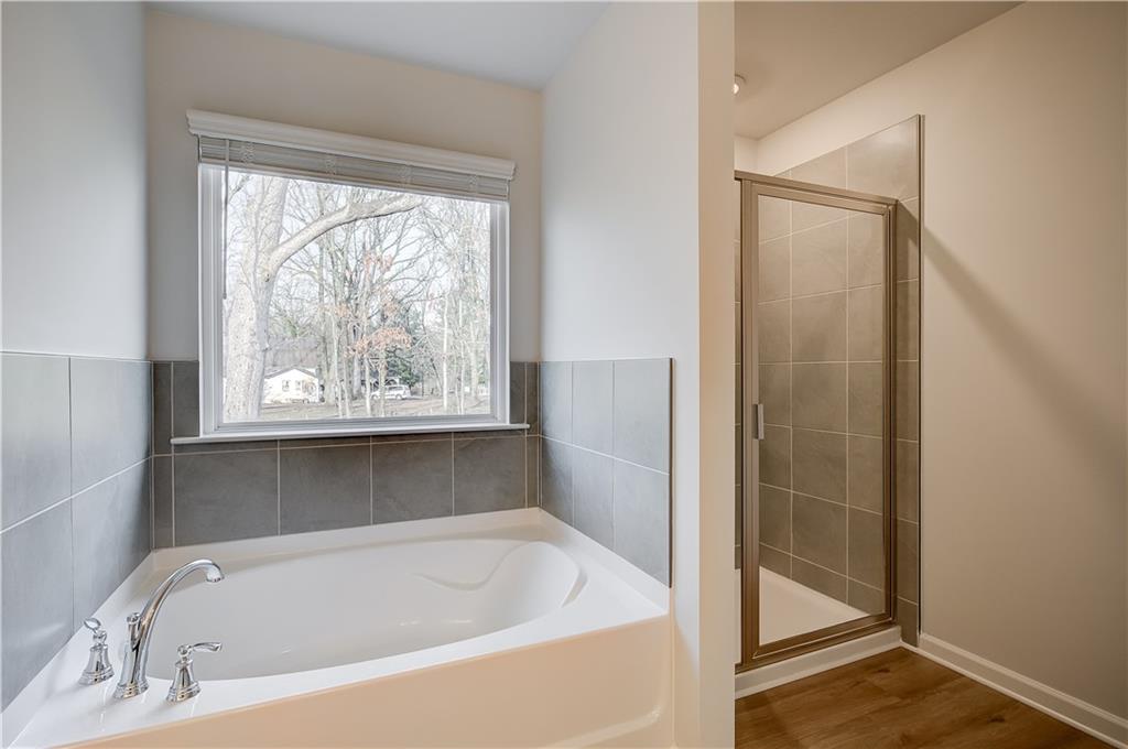 113 St Anne's Place Covington, GA 30016 - Photo 27 of 31 a white bath tub sitting next to a window