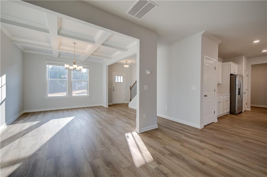 113 St Anne's Place Covington, GA 30016 - Photo 6 of 31 an empty room with wooden floor and windows