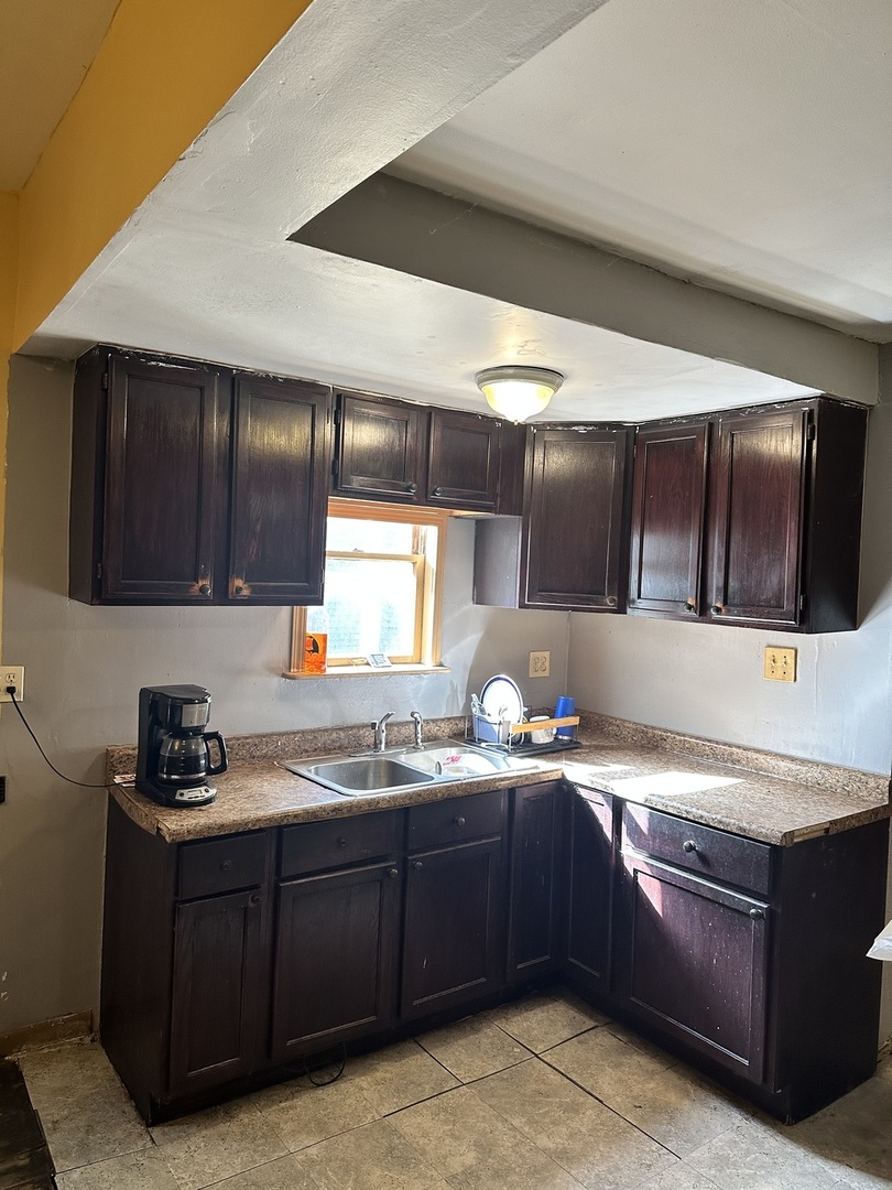 11730 South State Street Chicago, IL 60628 - Photo 2 of 11 a kitchen with stainless steel appliances granite countertop a sink and a stove