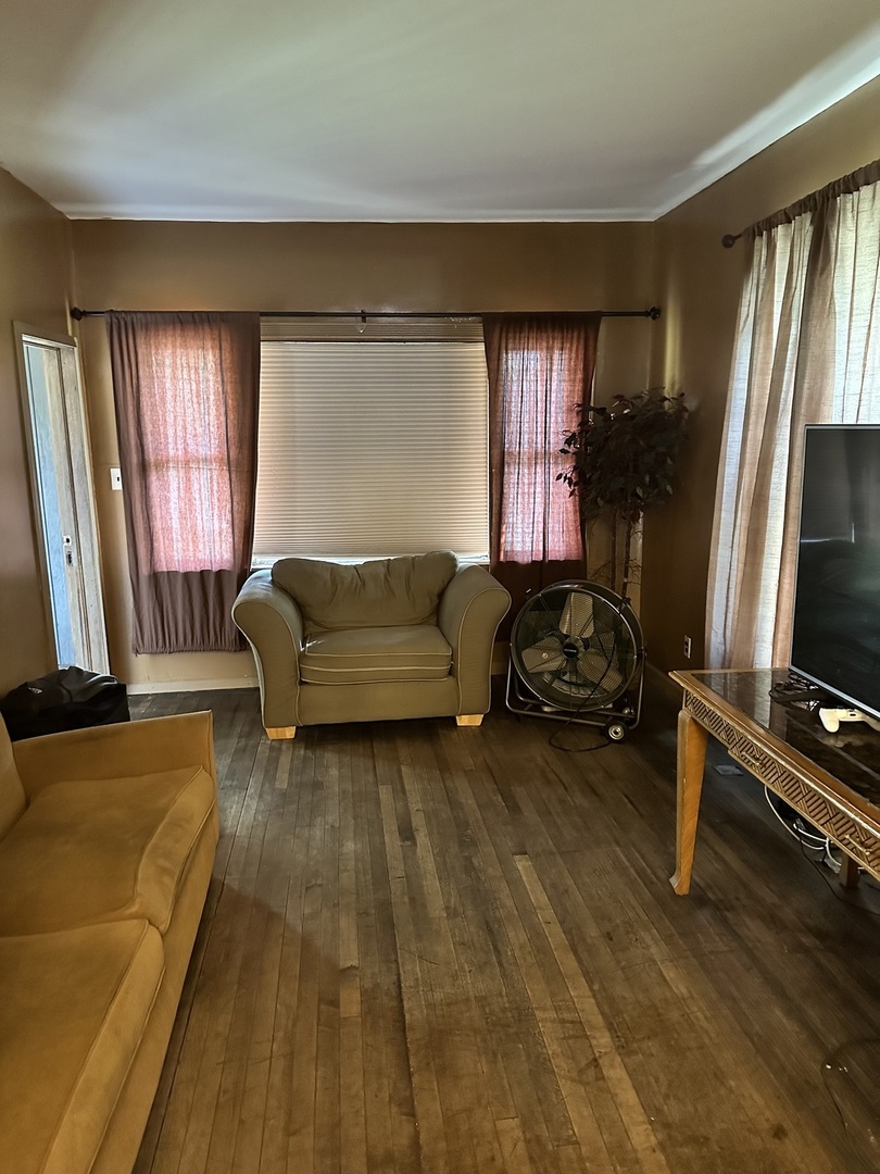 11730 South State Street Chicago, IL 60628 - Photo 5 of 11 a living room with furniture a window and a flat screen tv