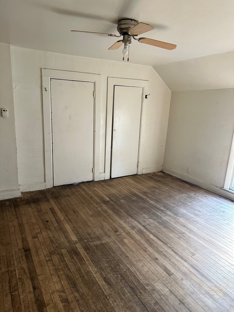 11730 South State Street Chicago, IL 60628 - Photo 6 of 11 a view of empty room with wooden floor and ceiling fan