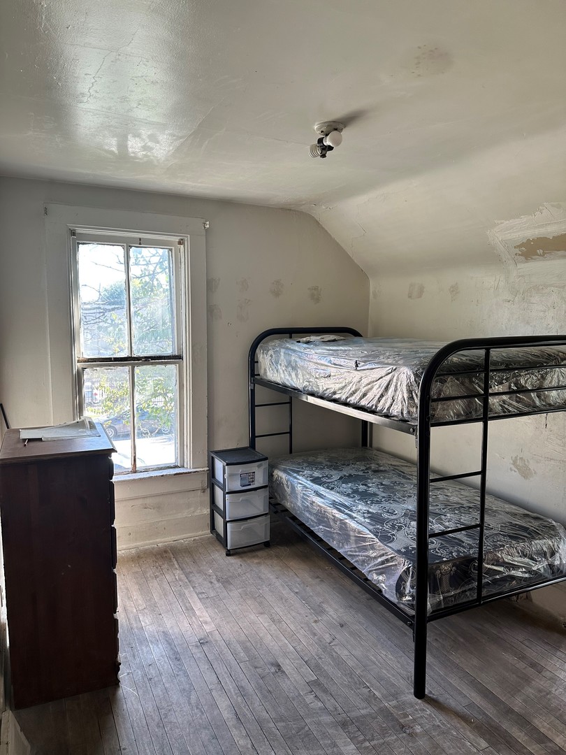 11730 South State Street Chicago, IL 60628 - Photo 7 of 11 a bedroom with a bed and a window