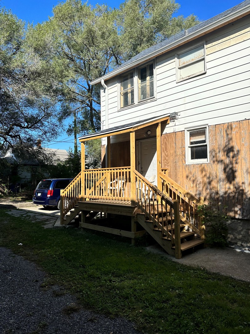 11730 South State Street Chicago, IL 60628 - Photo 10 of 11 a view of a house with a yard