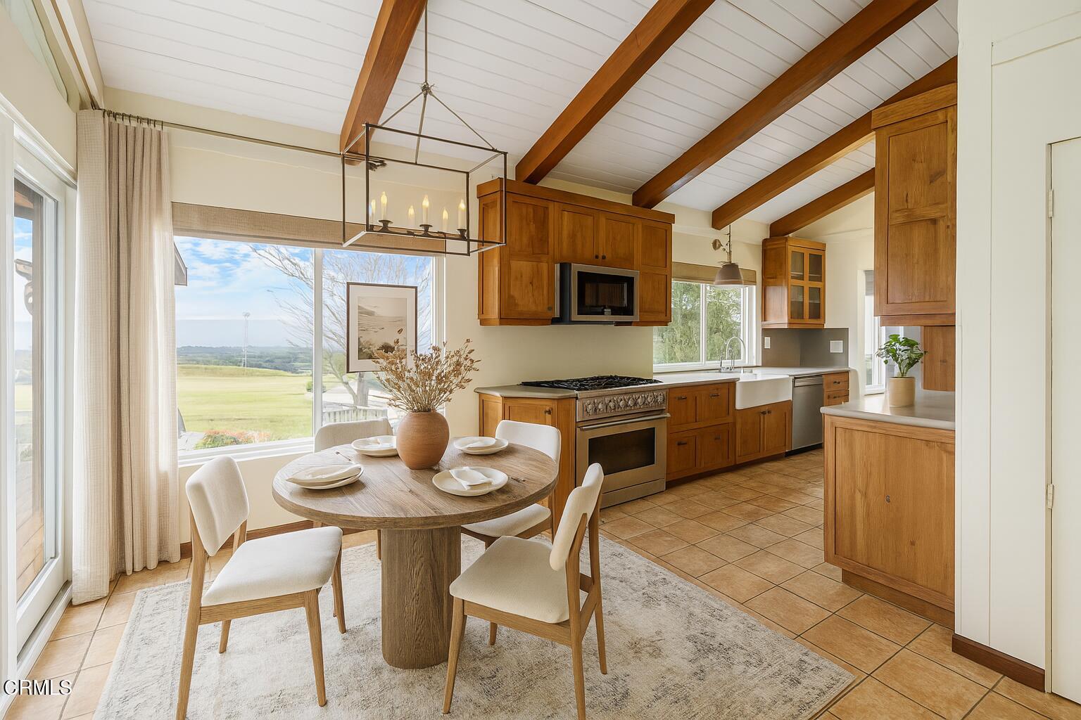 2851 Tapadero Road Solvang, CA 93463 - Photo 10 of 38 a kitchen with a table chairs microwave and cabinets