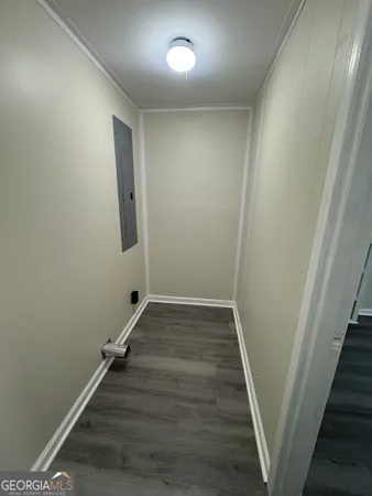 a view of an empty room with wooden floor