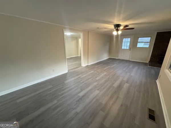 wooden floor in an empty room with a window