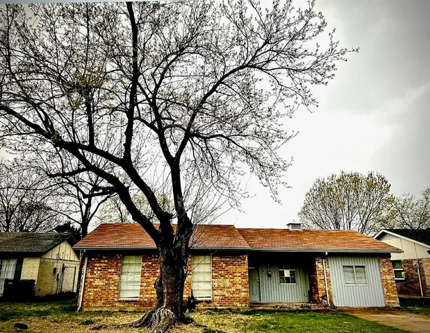 a view of a large building with large trees