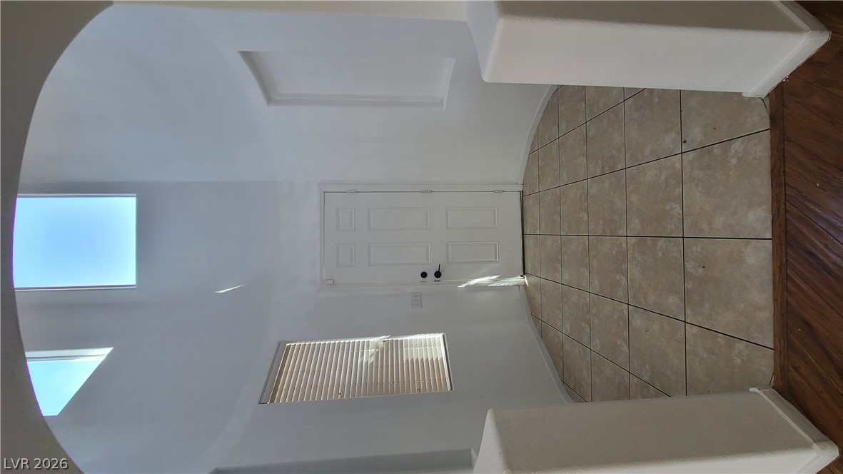 8944 Rutherford Grove Street Las Vegas, NV 89148 - Photo 3 of 35 A graceful entry with vaulted ceilings and a skylight creates a welcoming atmosphere.
