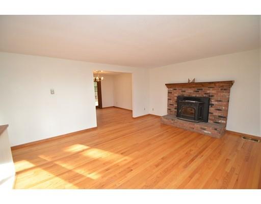 127 Leverett Road Amherst, MA 01002 - Photo 11 of 30 a view of empty room with wooden floor and fireplace