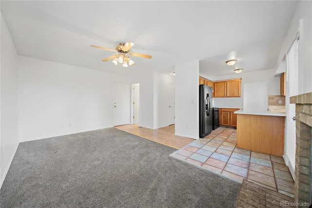 wooden floor fireplace and windows in an empty room