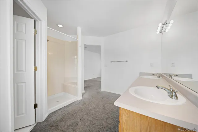 a bathroom with a sink double vanity granite tub and shower