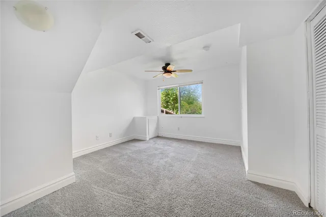 an empty room with a empty space and windows