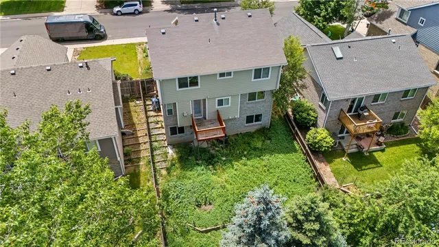 an aerial view of a city with lots of residential buildings and ocean view in back
