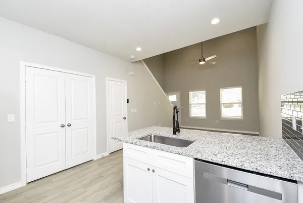 a kitchen with kitchen island a counter top space cabinets and stainless steel appliances