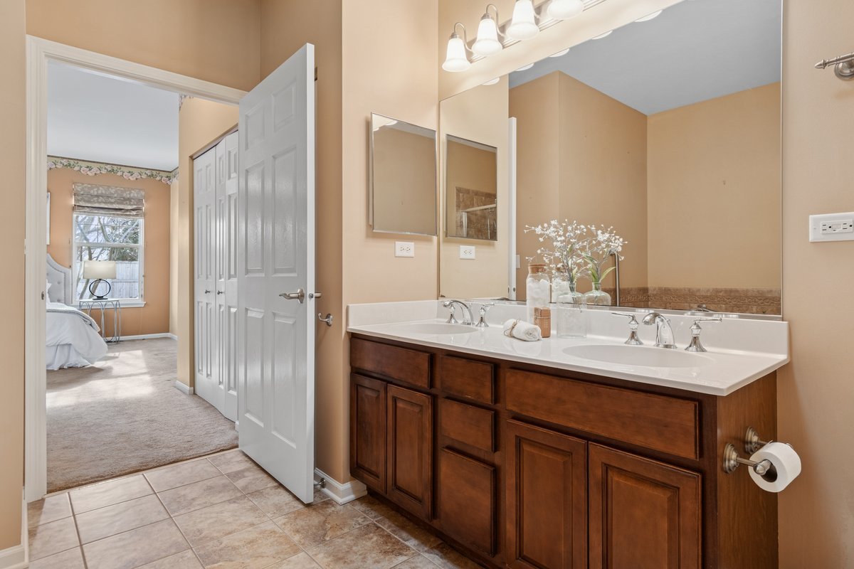 2905 Normandy Circle Naperville, IL 60564 - Photo 14 of 45 a bathroom with a double vanity sink a and mirror