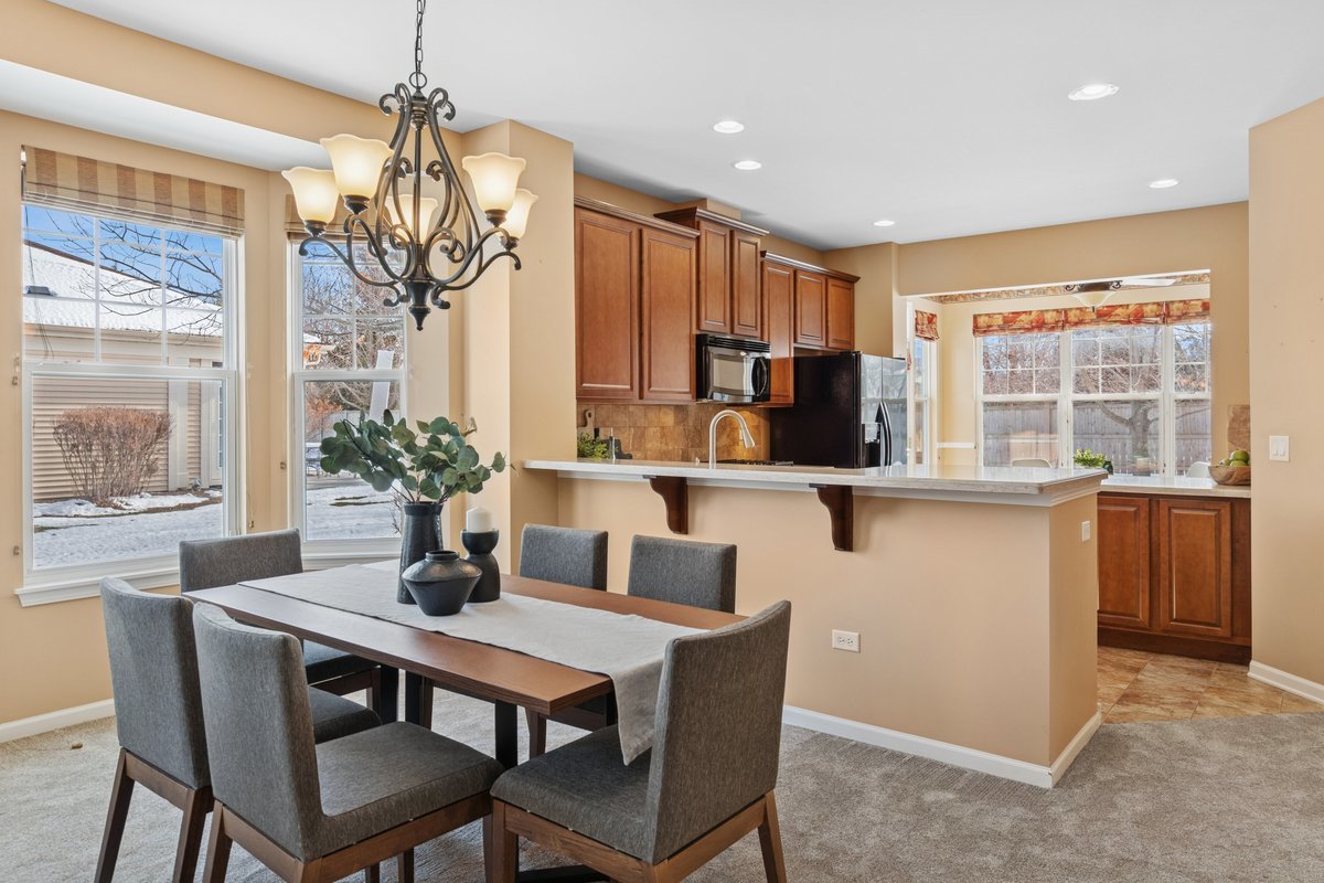 2905 Normandy Circle Naperville, IL 60564 - Photo 5 of 45 a dining room with furniture a chandelier and window