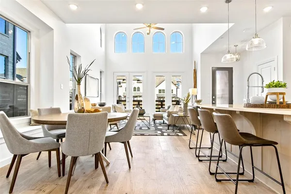 a view of a a dining room with furniture window and wooden floor