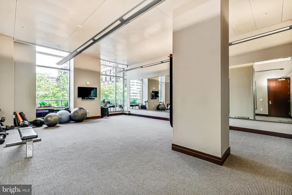 a living room with furniture and large windows