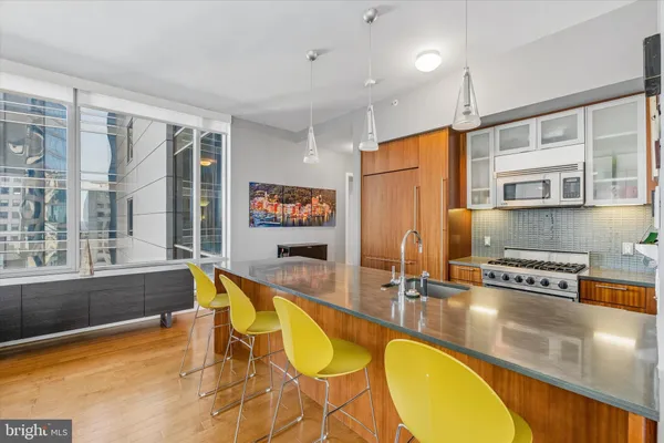 a kitchen with stainless steel appliances granite countertop a sink and cabinets