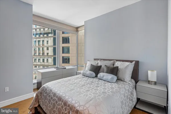 a large bed sitting in a bedroom next to a window