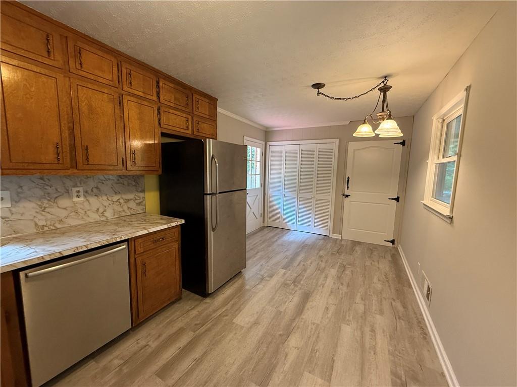 3155 Oak Drive Lawrenceville, GA 30044 - Photo 11 of 46 a kitchen with granite countertop a refrigerator and a sink
