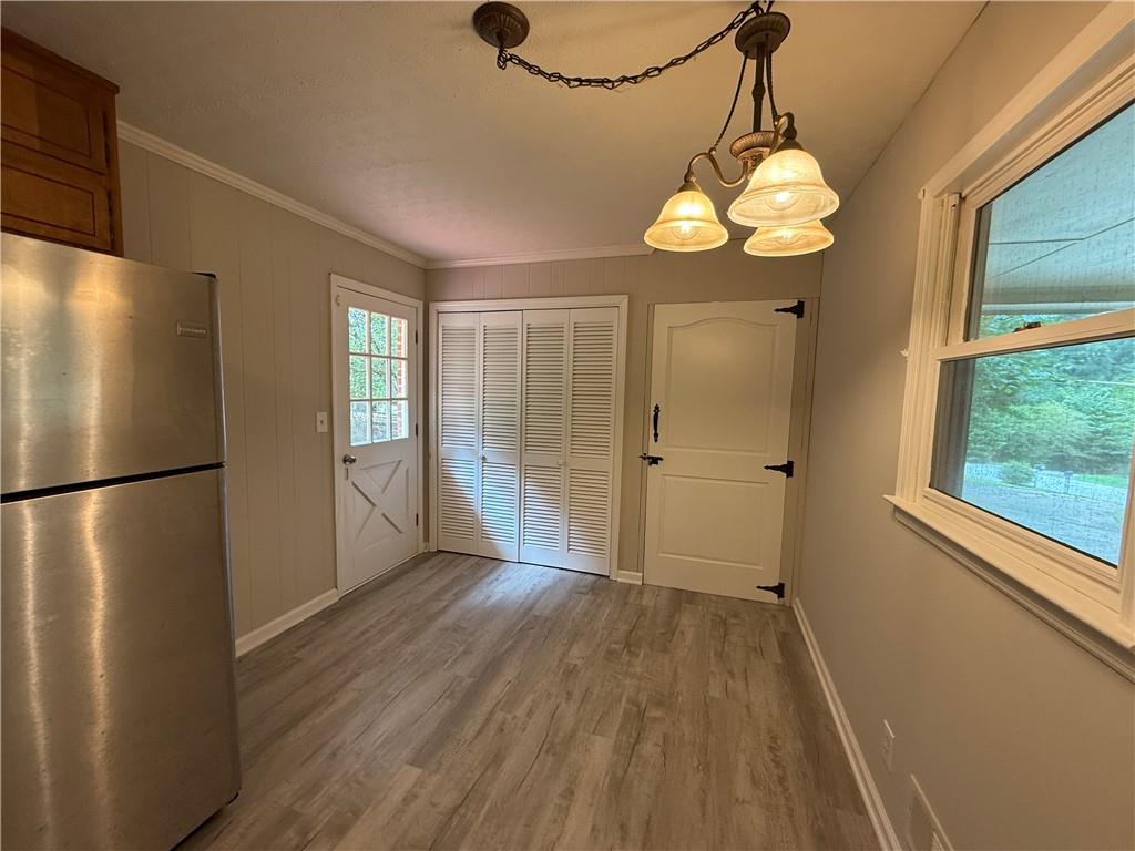 3155 Oak Drive Lawrenceville, GA 30044 - Photo 12 of 46 a view of a kitchen with a refrigerator wooden floor and a window