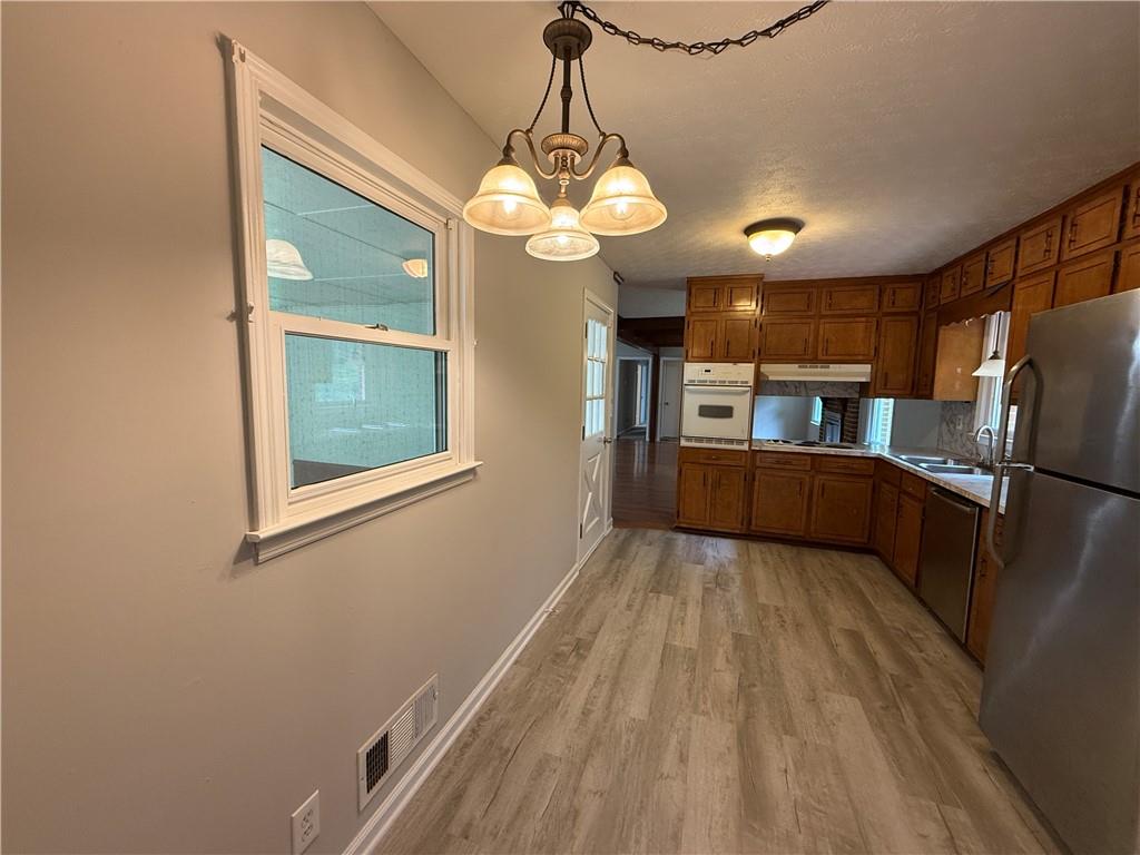 3155 Oak Drive Lawrenceville, GA 30044 - Photo 13 of 46 a view of a kitchen with a sink microwave and cabinets