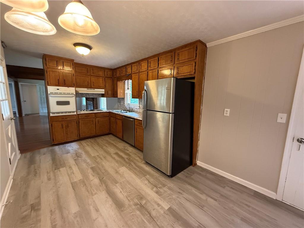 3155 Oak Drive Lawrenceville, GA 30044 - Photo 14 of 46 a kitchen with stainless steel appliances granite countertop a refrigerator and a sink