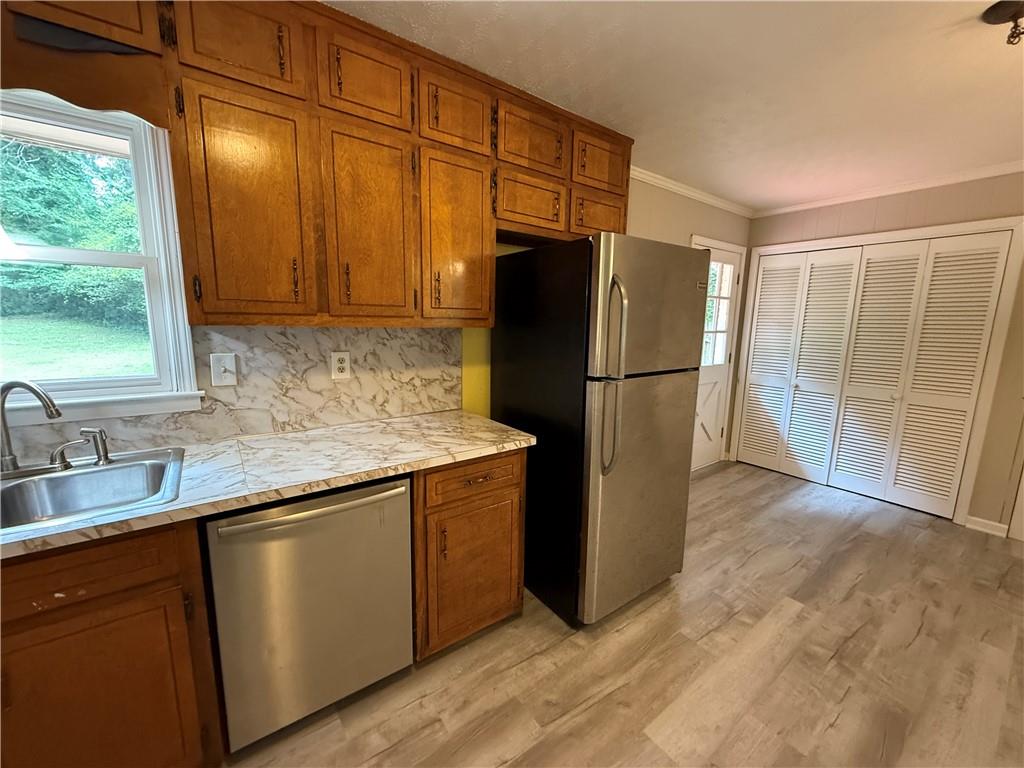 3155 Oak Drive Lawrenceville, GA 30044 - Photo 17 of 46 a kitchen with granite countertop a refrigerator and a sink