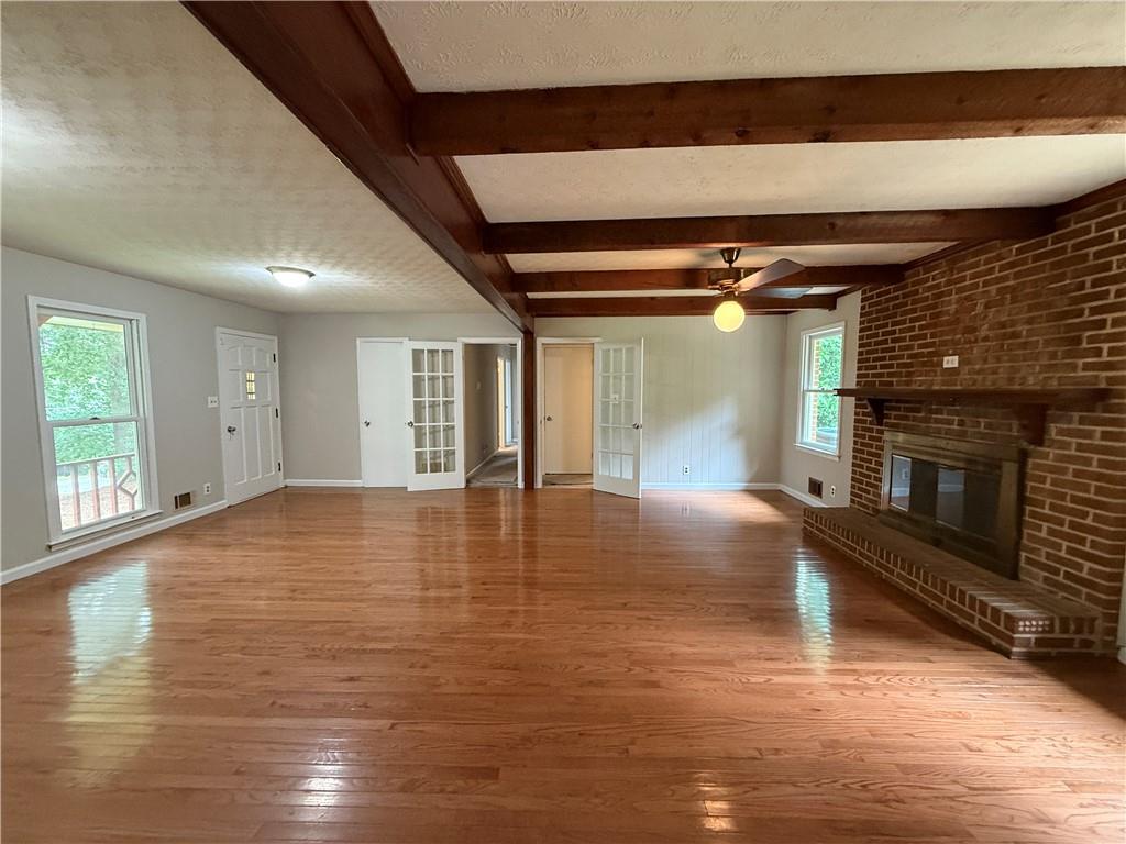 3155 Oak Drive Lawrenceville, GA 30044 - Photo 19 of 46 a view of empty room with wooden floor and fireplace