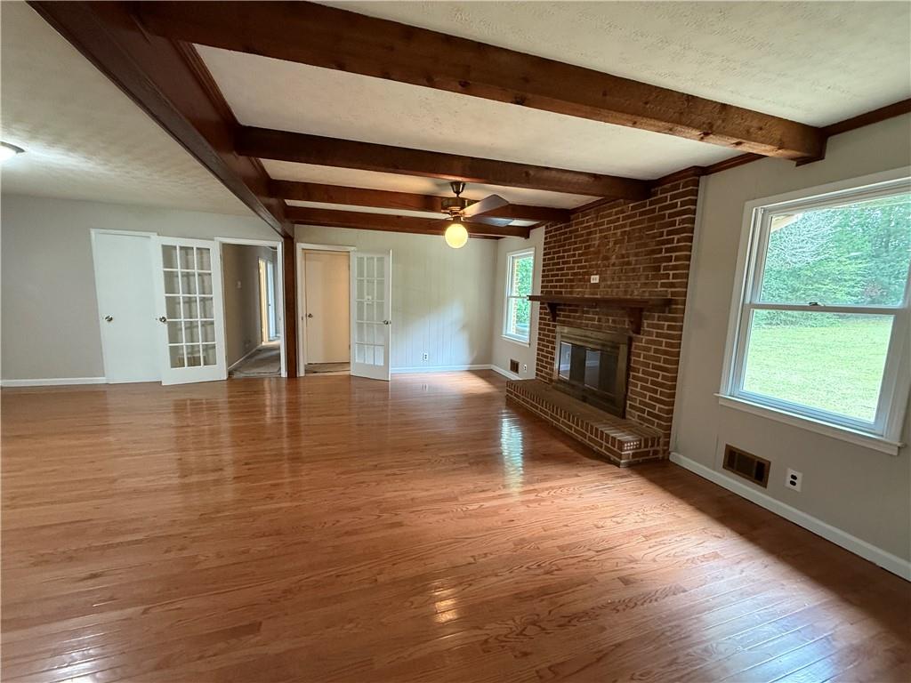 3155 Oak Drive Lawrenceville, GA 30044 - Photo 20 of 46 a view of empty room with wooden floor and fireplace