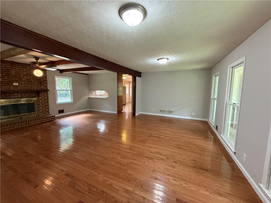 3155 Oak Drive Lawrenceville, GA 30044 - Photo 22 of 46 an empty room with wooden floor and windows