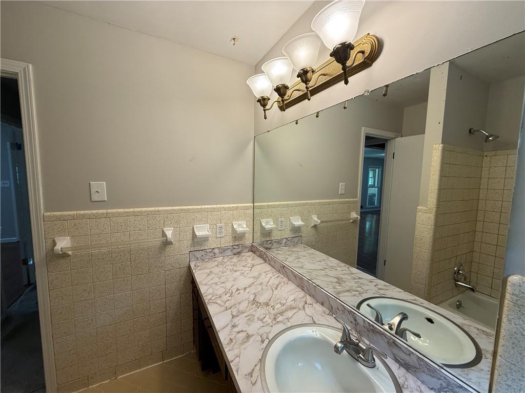 3155 Oak Drive Lawrenceville, GA 30044 - Photo 25 of 46 a bathroom with a granite countertop sink a mirror and shower