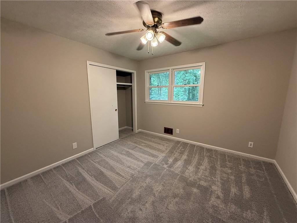 3155 Oak Drive Lawrenceville, GA 30044 - Photo 35 of 46 a view of a room with a ceiling fan and a window